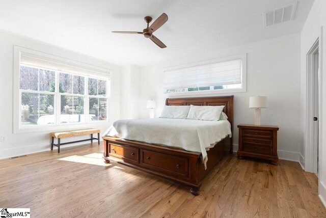 bedroom with ceiling fan and light hardwood / wood-style flooring