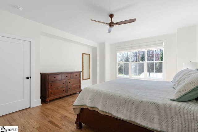 bedroom with ceiling fan and light hardwood / wood-style floors