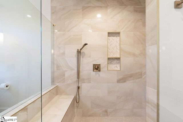 bathroom with tiled shower