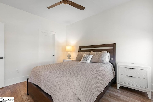 bedroom with ceiling fan and wood-type flooring