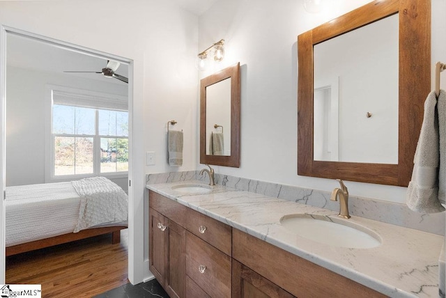 bathroom with ceiling fan, vanity, and wood-type flooring