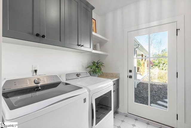 washroom featuring cabinets and washer and dryer