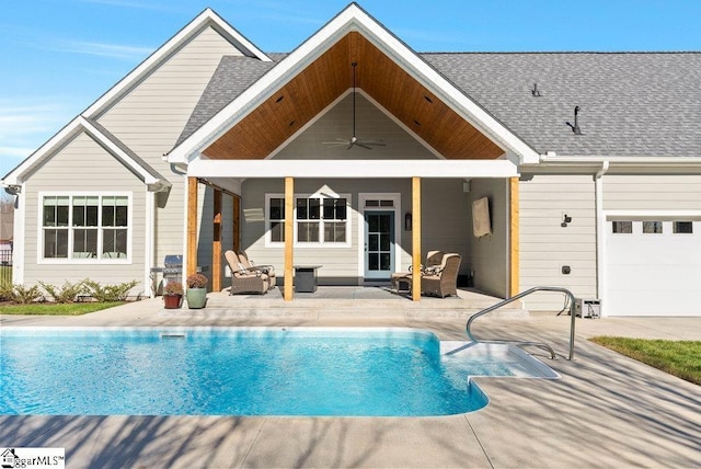 back of house with ceiling fan, a garage, and a patio area