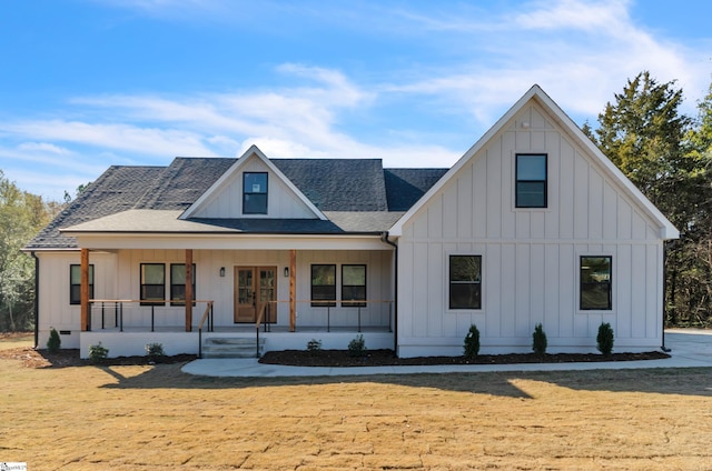 modern inspired farmhouse with covered porch and a front yard