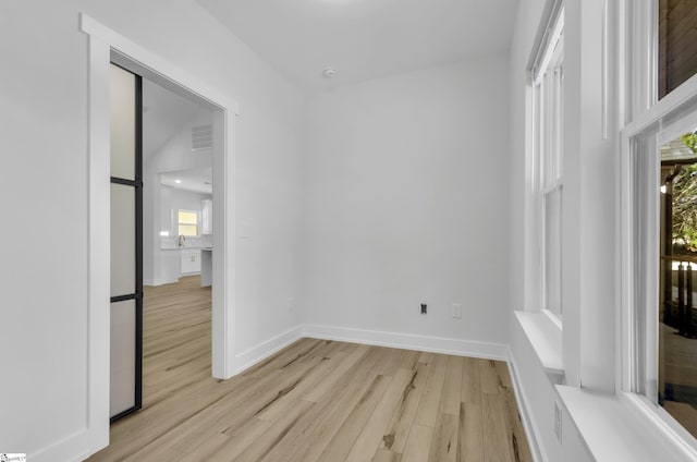 unfurnished room with light wood-type flooring