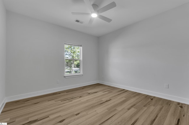 empty room with ceiling fan and light wood-type flooring