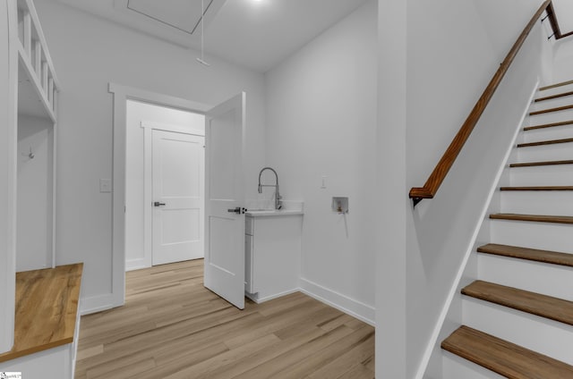 staircase with hardwood / wood-style flooring