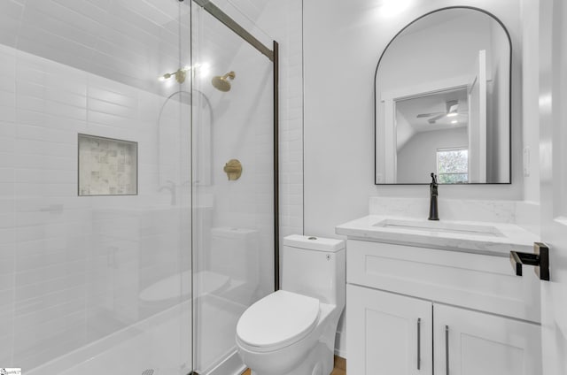 bathroom featuring ceiling fan, vanity, an enclosed shower, and toilet