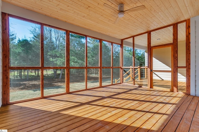 unfurnished sunroom with ceiling fan and wooden ceiling