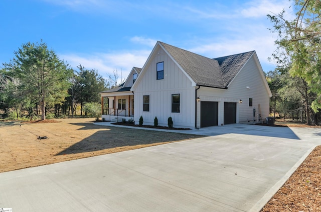 modern farmhouse style home featuring covered porch and a garage