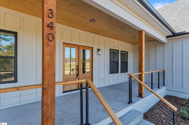 entrance to property with covered porch and french doors