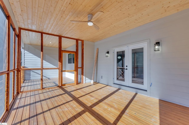 unfurnished sunroom featuring french doors, ceiling fan, and wood ceiling