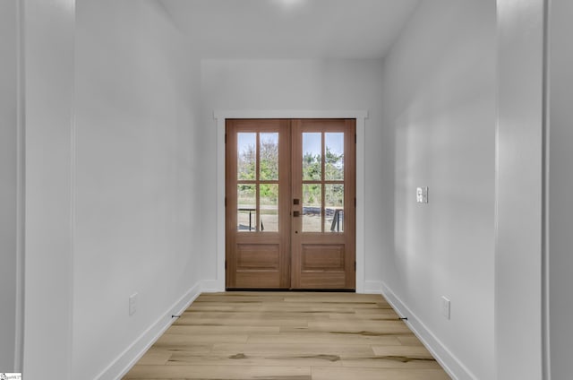 doorway with light wood-type flooring and french doors