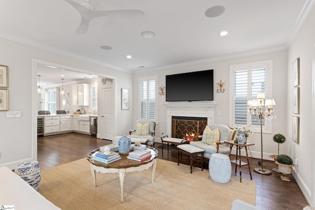 living room with dark hardwood / wood-style flooring, a wealth of natural light, and crown molding