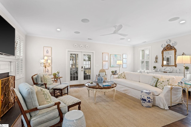 living room featuring wood-type flooring, french doors, crown molding, and ceiling fan