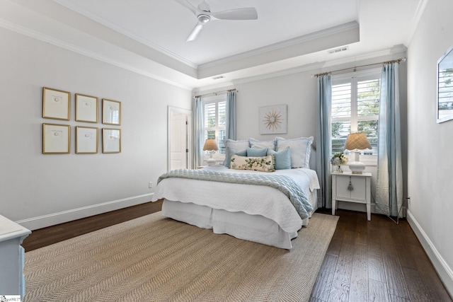 bedroom with hardwood / wood-style floors, ceiling fan, crown molding, and multiple windows