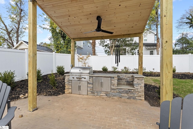 view of patio / terrace featuring a grill, ceiling fan, and exterior kitchen