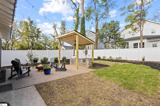 view of yard with a fire pit and a patio