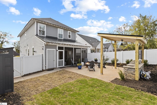 back of house with a sunroom, a yard, and a patio