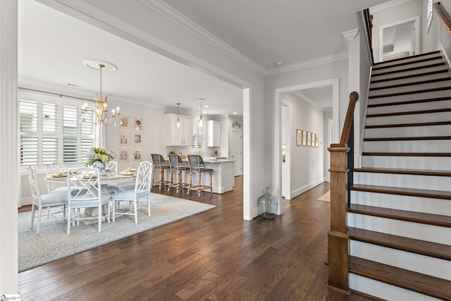 dining area with ornamental molding, dark wood-type flooring, and a chandelier