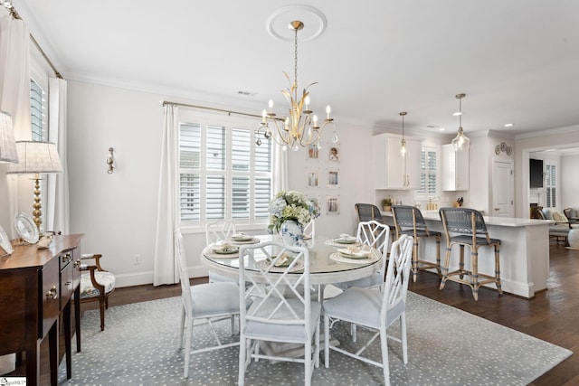 dining space featuring crown molding, dark wood-type flooring, and a notable chandelier