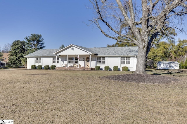 ranch-style house featuring a porch, a shed, and a front lawn