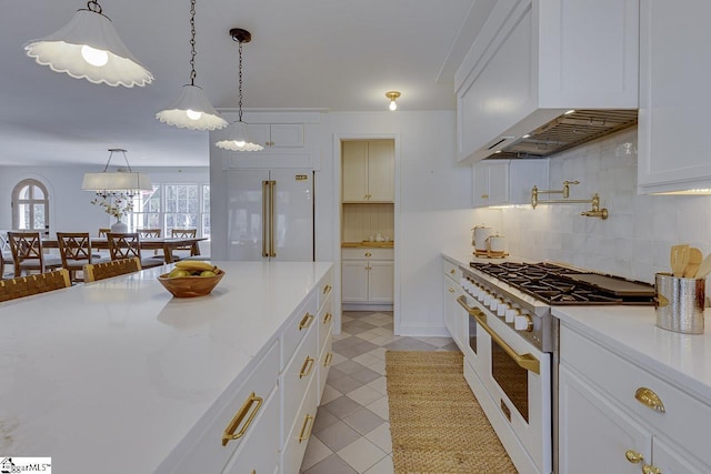 kitchen featuring white cabinetry, high quality appliances, pendant lighting, and custom range hood