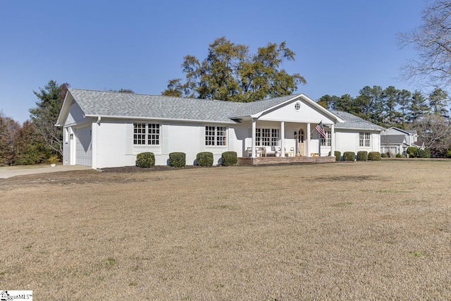 ranch-style home with a front lawn, a porch, and a garage