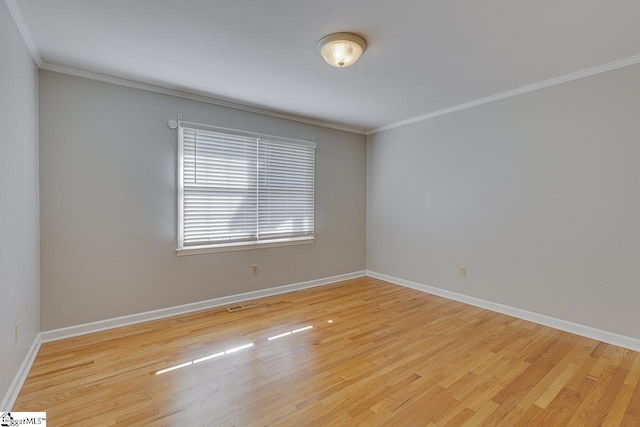 unfurnished room with crown molding and wood-type flooring