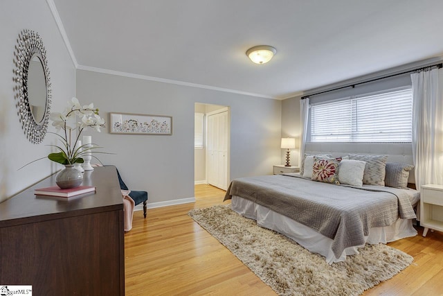 bedroom featuring light wood-type flooring and ornamental molding