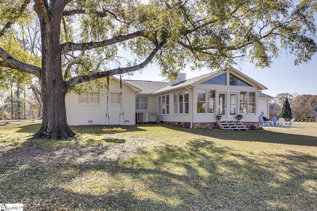 back of house featuring a sunroom and a yard