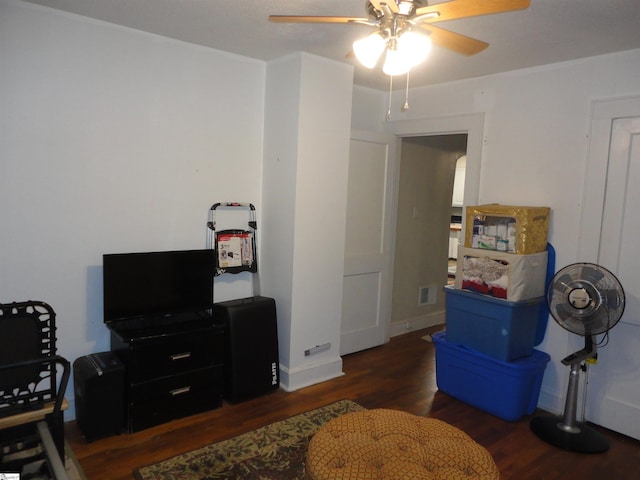 living area with dark hardwood / wood-style floors and ceiling fan