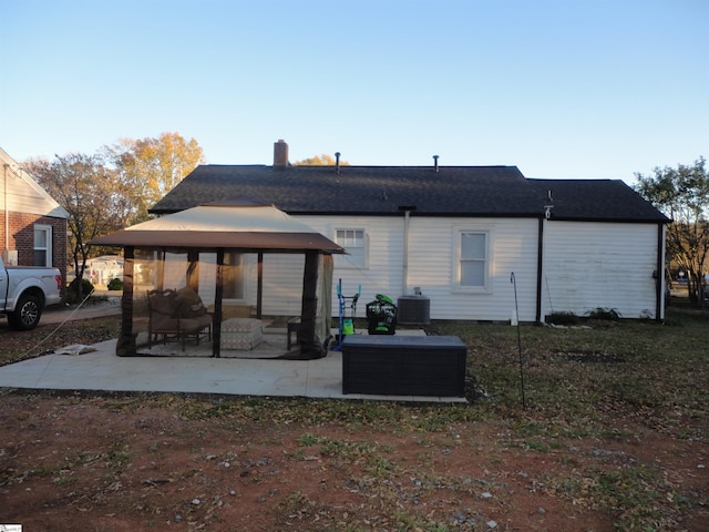 rear view of property featuring a gazebo, a patio, and central AC unit