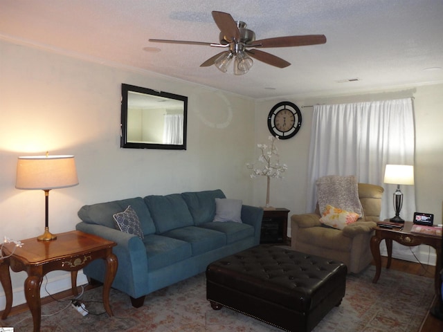 living room featuring a textured ceiling, ceiling fan, and crown molding