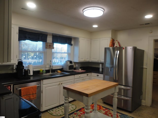 kitchen with white cabinets, sink, and appliances with stainless steel finishes