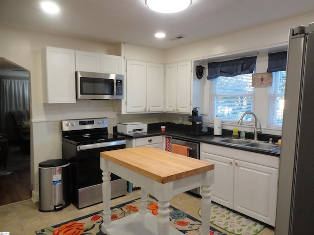 kitchen featuring white cabinetry, sink, and appliances with stainless steel finishes