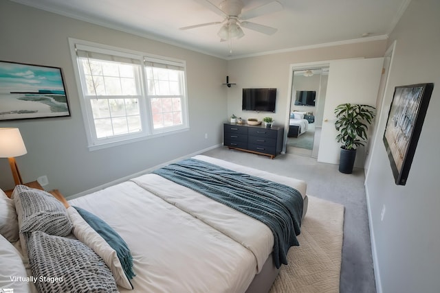 carpeted bedroom featuring ceiling fan, ornamental molding, and a closet