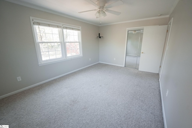 unfurnished room featuring light colored carpet, ceiling fan, and crown molding