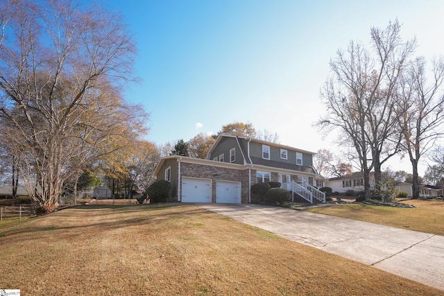 view of property featuring a front lawn and a garage