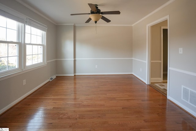 unfurnished room featuring hardwood / wood-style flooring, ceiling fan, and crown molding