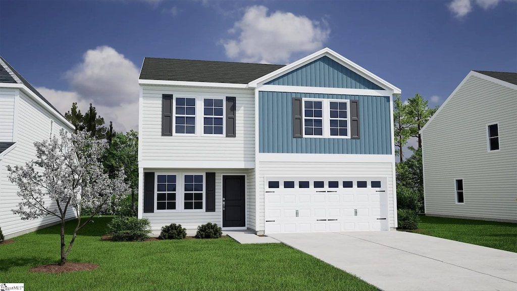 view of front of property featuring a front yard and a garage