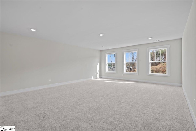 spare room featuring light colored carpet