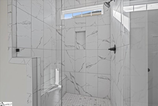 bathroom with tiled shower