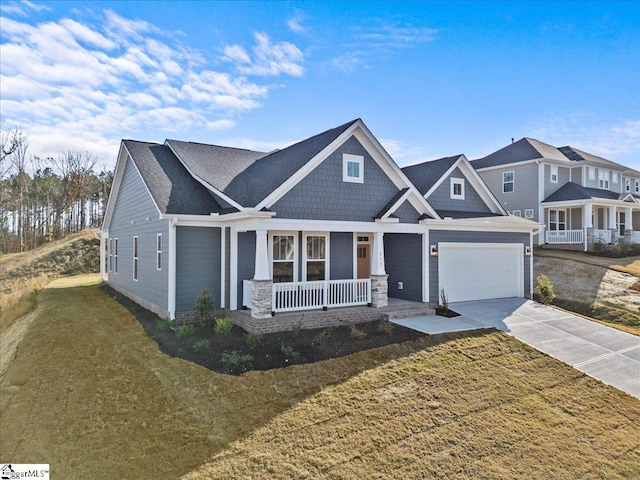 craftsman house featuring a front yard, a porch, and a garage