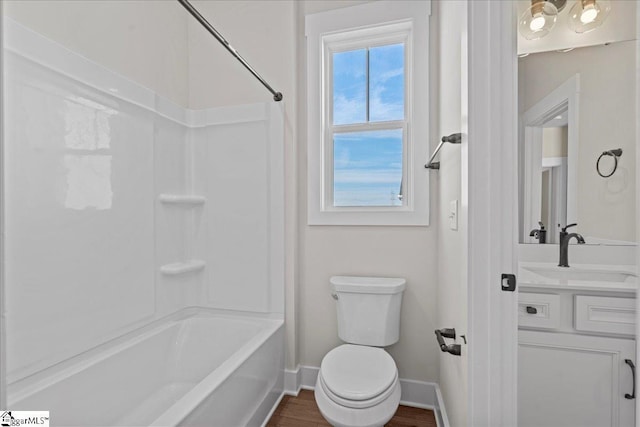 full bathroom with hardwood / wood-style floors, vanity, shower / bathtub combination, and toilet