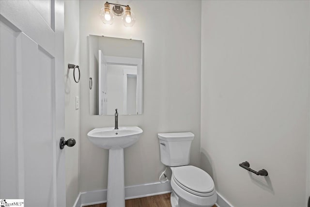 bathroom featuring hardwood / wood-style floors and toilet