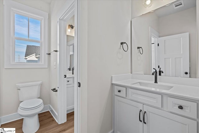 bathroom featuring vanity, toilet, and wood-type flooring