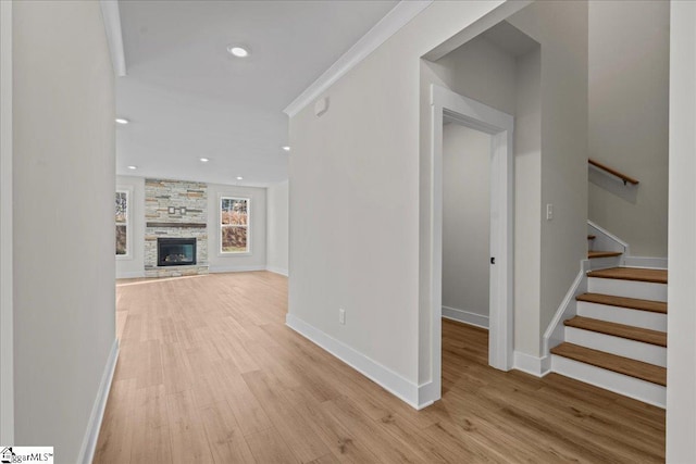 corridor featuring ornamental molding and light wood-type flooring