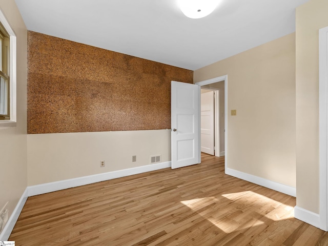 unfurnished room with light hardwood / wood-style flooring