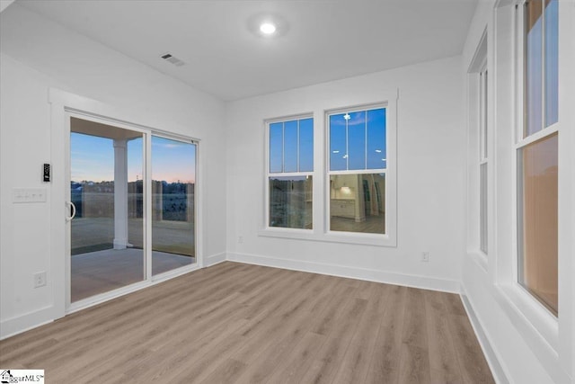 spare room featuring light hardwood / wood-style flooring